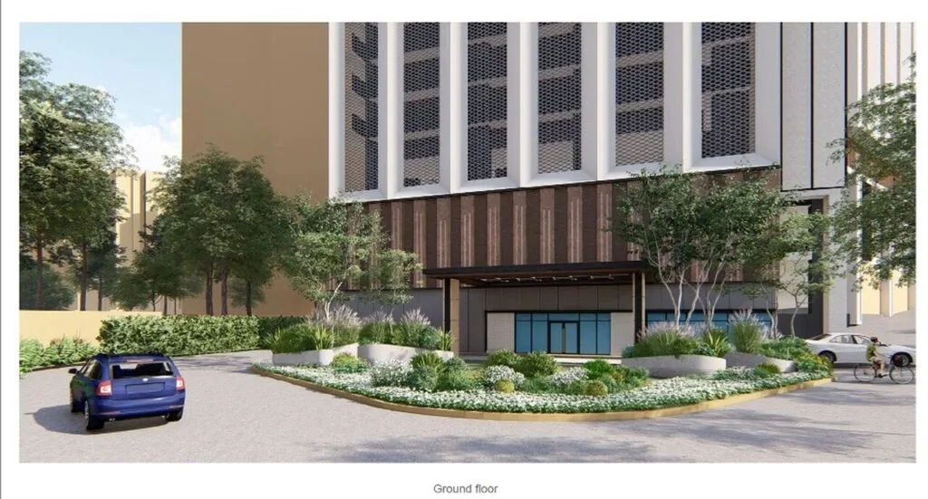 Landscaped driveway entrance at EXSIM CIQ Causewayz Square @ JBCC, with car drop-off point and surrounding greenery on the ground floor.