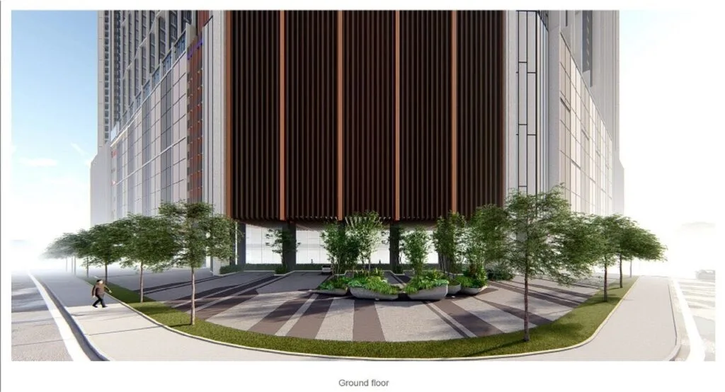 Ground floor plaza of Causewayz Square @ JBCC by EXSIM, featuring modern façade cladding with shaded walkways and trees along the street.