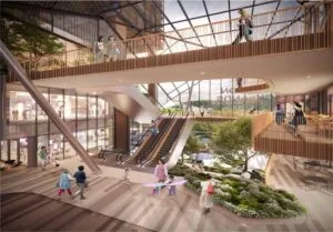 Interior view of The Bedrock’s vibrant retail promenade with escalators, boutique stores, and community-friendly design within Jesselton Docklands, Sabah.