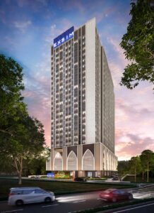 Evening view of Erinaz Suites by EXSIM featuring illuminated residential tower facade, arched podium design and landscaped entrance within Kubang Kerian residence setting.