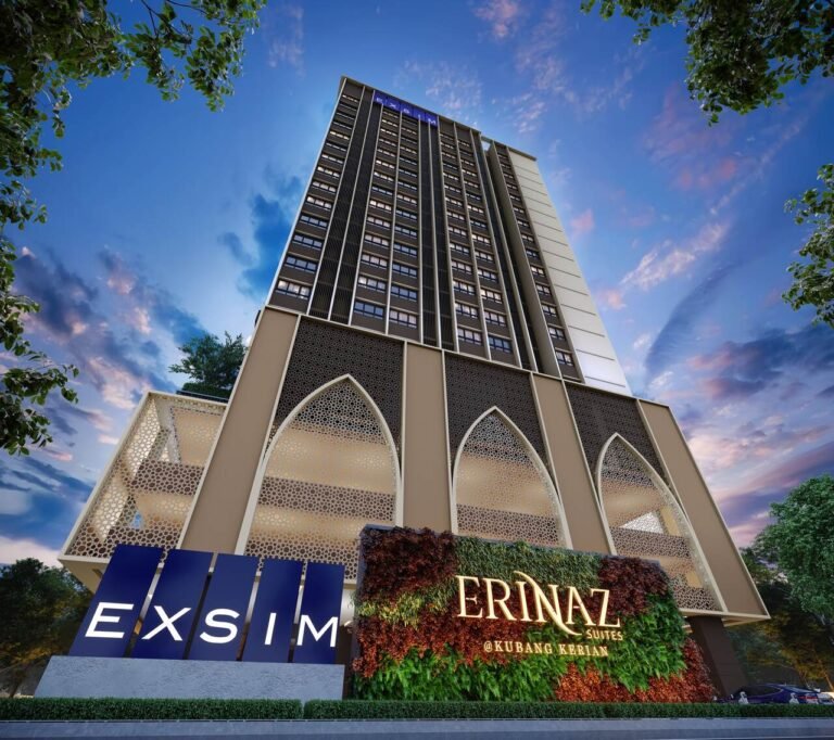 Low angle facade view of Erinaz Suites by EXSIM highlighting signature green wall signage, arched podium architecture and modern residential tower design.