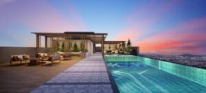 Waves cape pergola and rooftop pool deck at Erinaz Suites @ Kubang Kerian featuring sunset view, lounge seating and resort-style residential facilities.