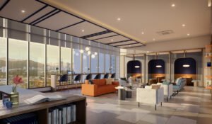 Co-working lounge at Keeperz Suites Penang featuring modern workspace, lounge seating and panoramic city views designed for flexible working lifestyle.