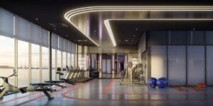 Spacious indoor gym at The Lighthauz Residences by EXSIM equipped with cardio machines, strength training zones and panoramic coastal views, enhancing daily living experience in lighthauz penang.