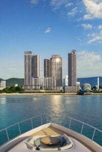 Waterfront perspective of The Lighthauz Residences Penang viewed from the sea, showcasing modern residential towers along the coastline with panoramic skyline and marina surroundings, highlighting its prime penang seafront condo location.