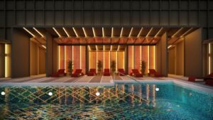 Rooftop pool lounge deck at Phoeniz Suites @ KLCC with poolside seating, illuminated leisure area and city skyline ambience.
