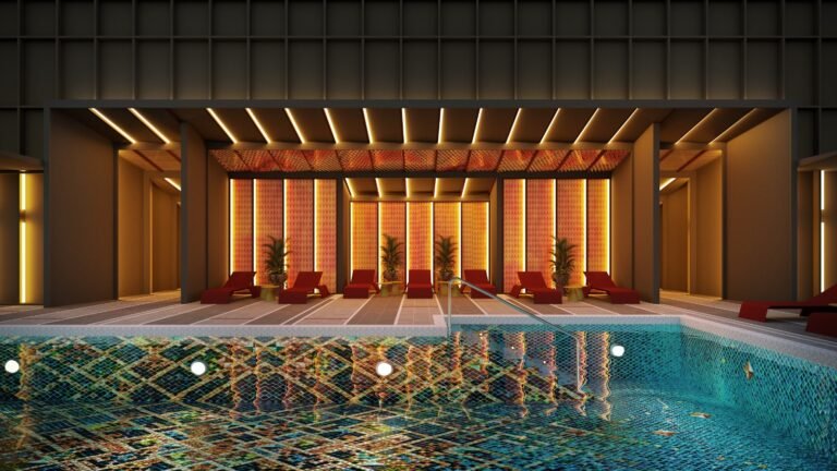 Rooftop pool lounge deck at Phoeniz Suites @ KLCC with poolside seating, illuminated leisure area and city skyline ambience.