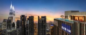 Skyline view from Phoeniz Suites @ KLCC featuring rooftop pool deck, EXSIM tower signage and Kuala Lumpur city landmarks.
