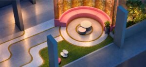 Garden Lounge at MABA Suitez seen from above with a curved pink sofa, two round tables, patterned paving and planted garden border