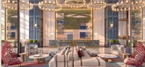 Hotel-style Grand Lobby at MABA Suitez, Kuala Lumpur, with a marble reception counter, feature art wall, lounge seating and ring chandeliers.