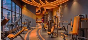 Gymnasium at MABA Suitez with strength-training machines and Kuala Lumpur skyline view