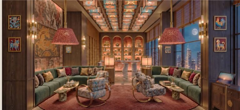 The Music Lounge at MABA Suitez with velvet sofas, a lantern ceiling, zodiac artwork and a night view of the Kuala Lumpur skyline