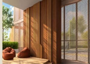 The Playmaker Hub at MABA Suitez featuring orange beanbag chairs, a timber seating platform, vertical wood panels and perforated screens.