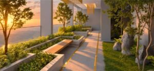 Sunken Lounge at MABA Suitez featuring a landscaped walkway, long timber bench, small trees, stone features and sunset views.