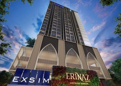 Low angle facade view of Erinaz Suites by EXSIM highlighting signature green wall signage, arched podium architecture and modern residential tower design.