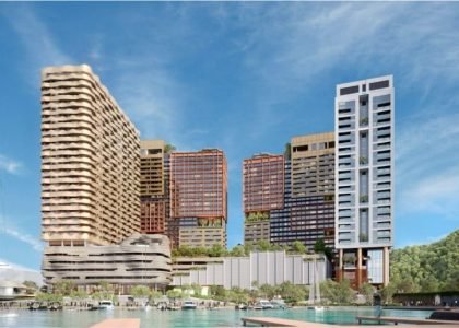 Seafront view of The Bedrock @ Jesselton Docklands by EXSIM Sabah, showing the full waterfront development against a backdrop of the South China Sea.